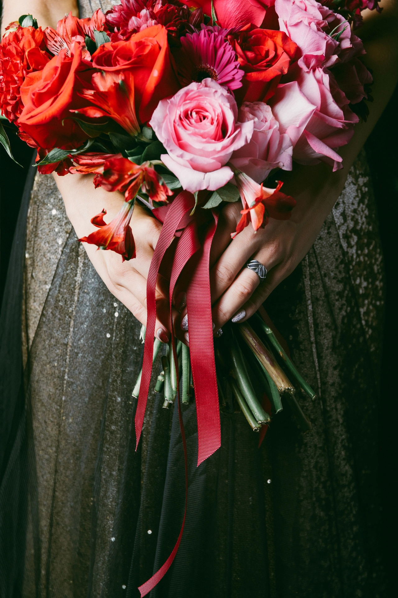 A unique bridal bouquet complements the bride’s dark dress in this rustic fine art wedding portrait.