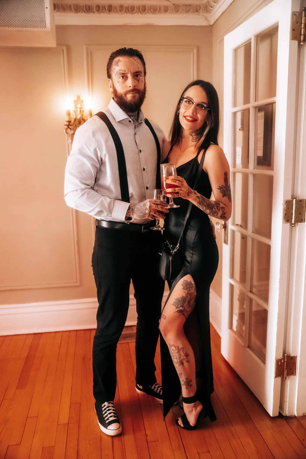 A cool, tattooed couple enjoying cocktails during the reception—a candid moment from Southern Ontario wedding photography that captures personality and style.