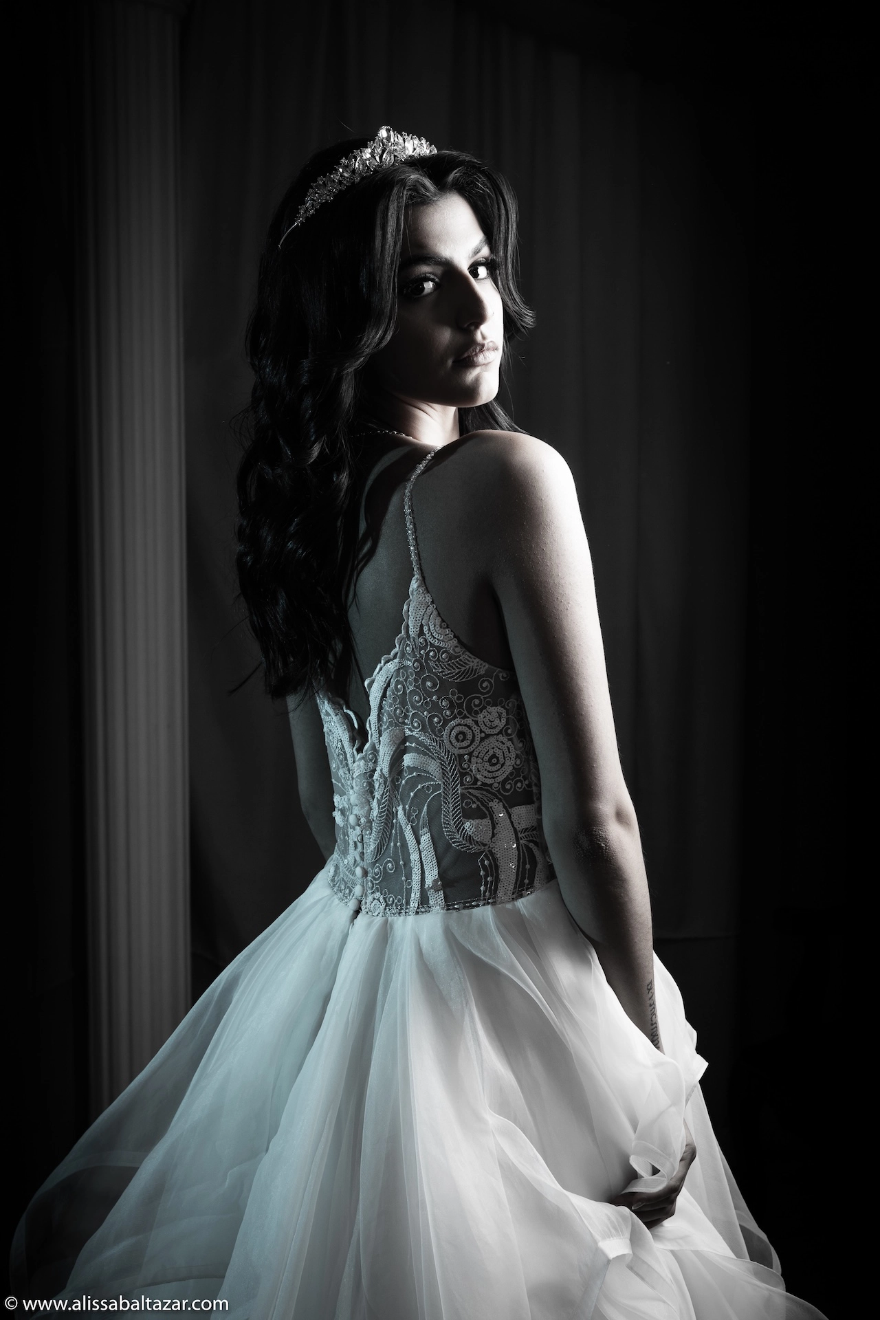 A timeless black-and-white portrait of the bride looking back over her shoulder — a classic pose captured in Southern Ontario wedding photography style.