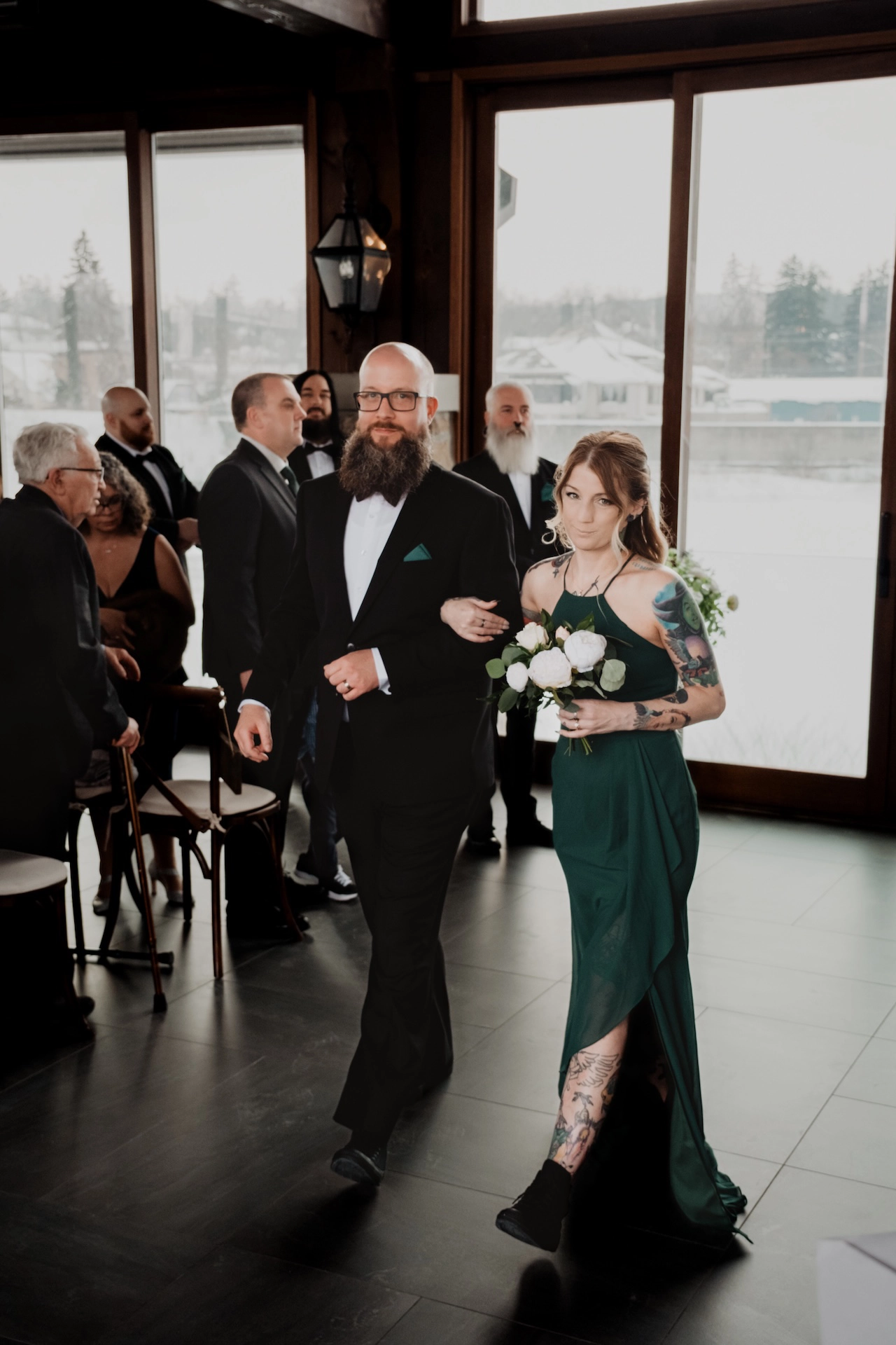 The best man and maid of honour share a light-hearted moment as they walk down the aisle at a wedding in Southern Ontario.