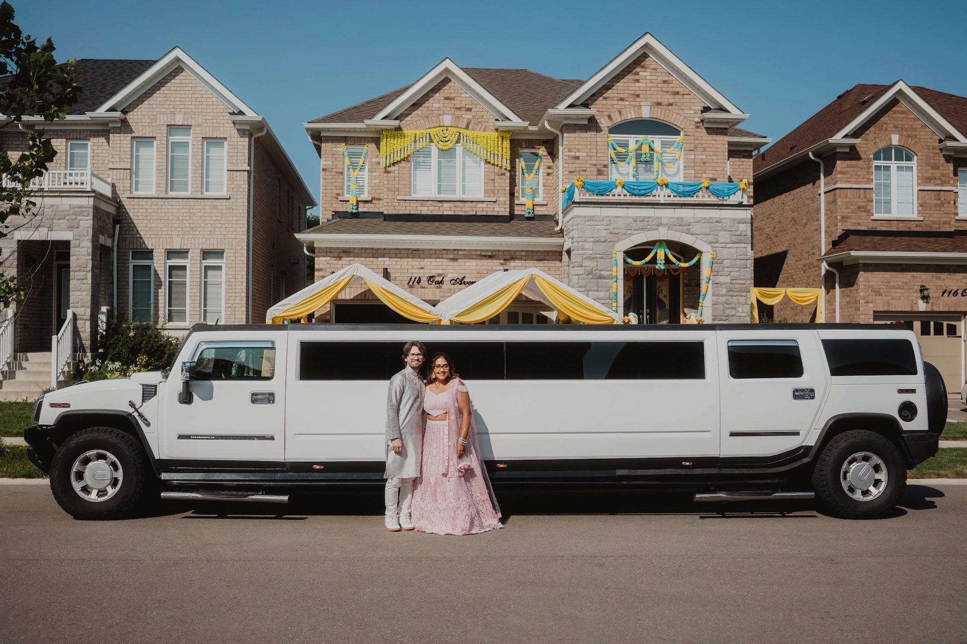 Beautiful Indian couple posing next to a limo, captured in vibrant and elegant style showcasing Brantford and Southern Ontario wedding photography.