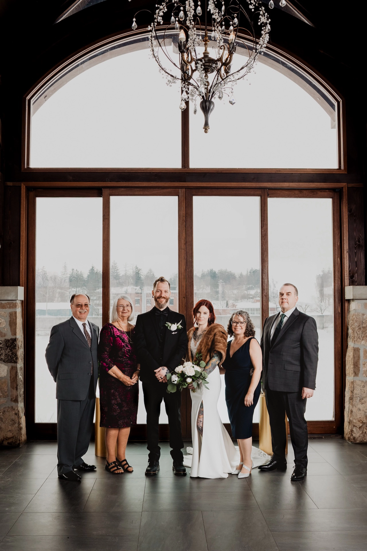 Beautifully composed group photo taken inside the ceremony building at Cambridge Mill, a popular wedding venue near Brantford.