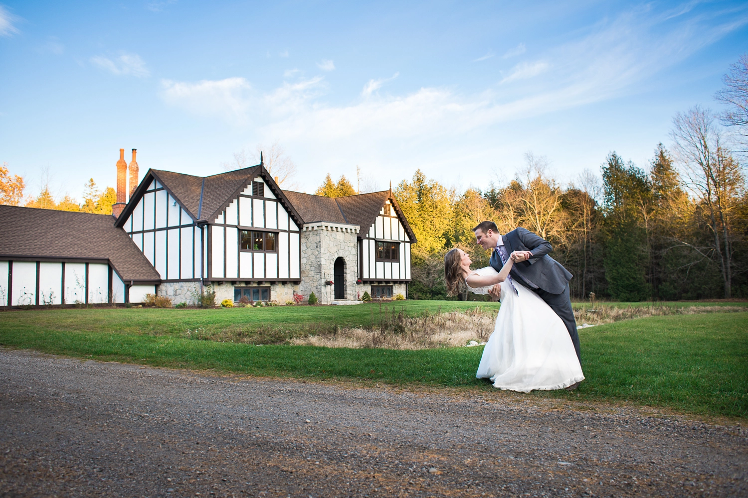 Romantic wedding couple sharing a dance in front of the stunning Erin Estate castle venue.
