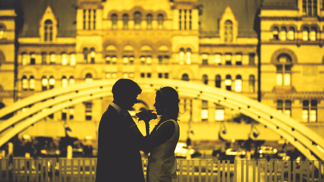 Silhouette of couple standing before golden castle at sunset – romantic wedding inspiration