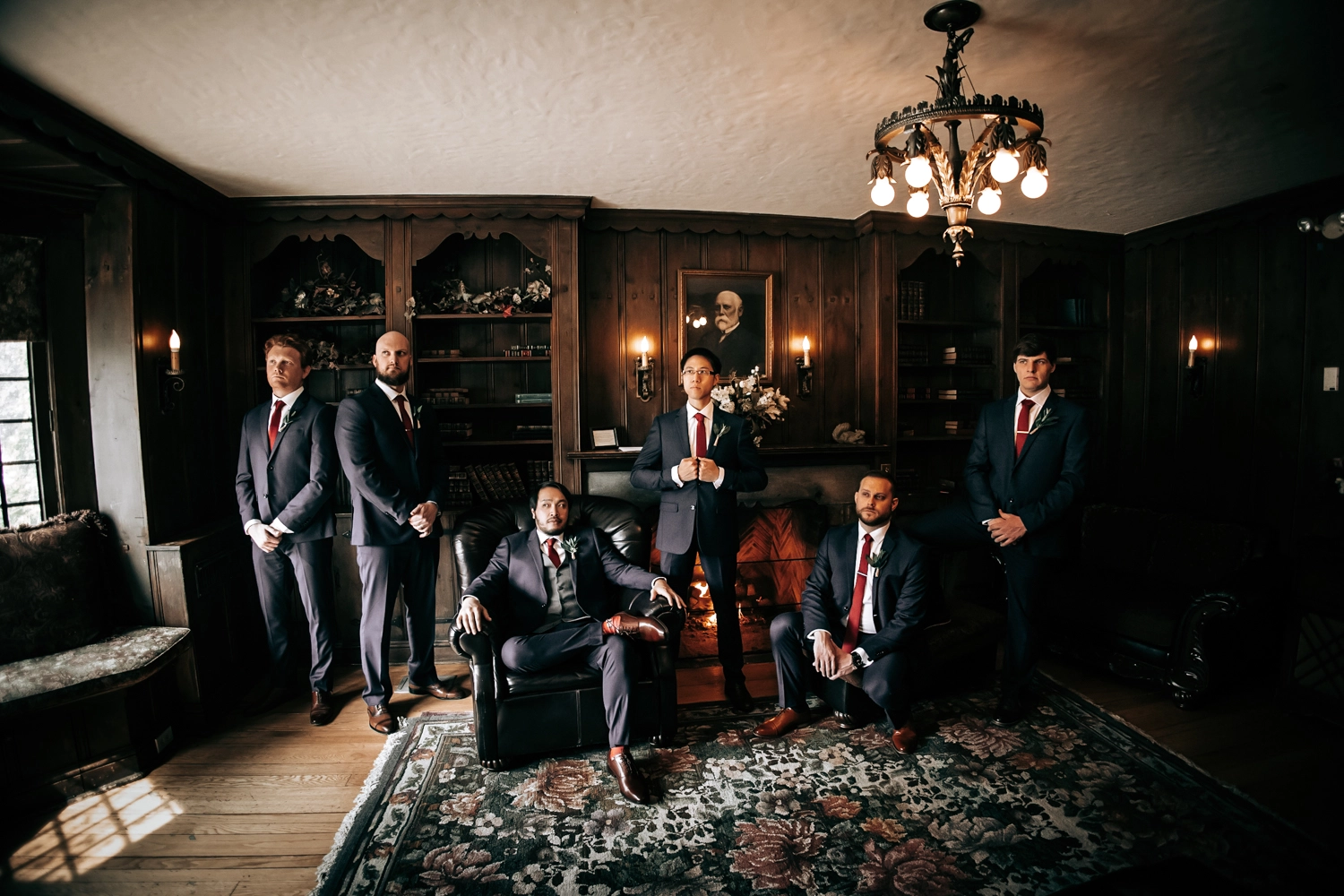 Cinematic and carefully posed groomsmen group in the moody, mysterious library room at Polletta Mansion, captured by Brantford wedding photographer Alissa Baltazar, serving Southern Ontario weddings.