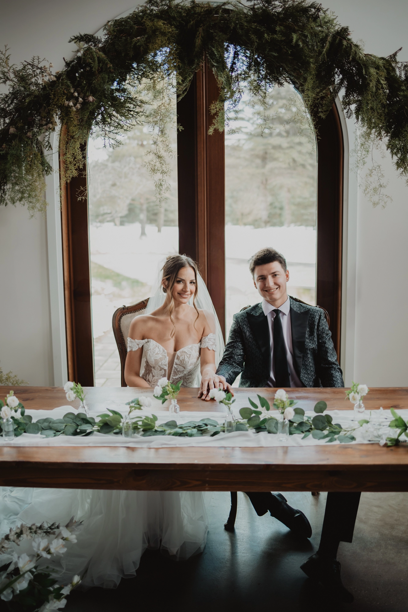 A romantic moment as the couple sits together at their beautifully set wedding table at Erin Estate.