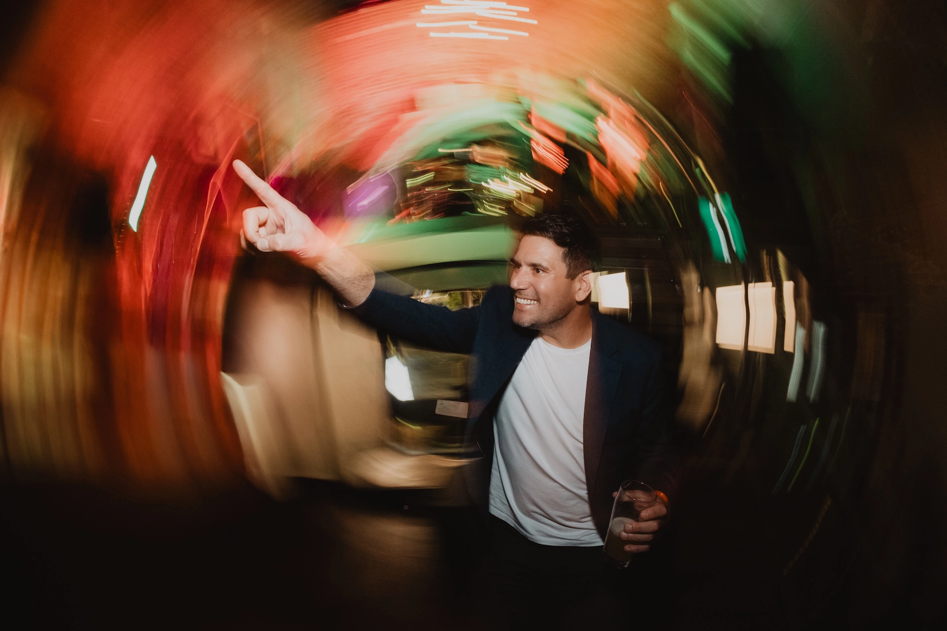 Capturing the energy of the party, this shot of a man dancing is enhanced with a dynamic drag the shutter effect, creating a sense of motion.