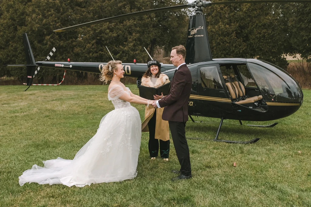 Bride and groom stepping toward a helicopter, embracing an adventurous and unforgettable wedding experience.