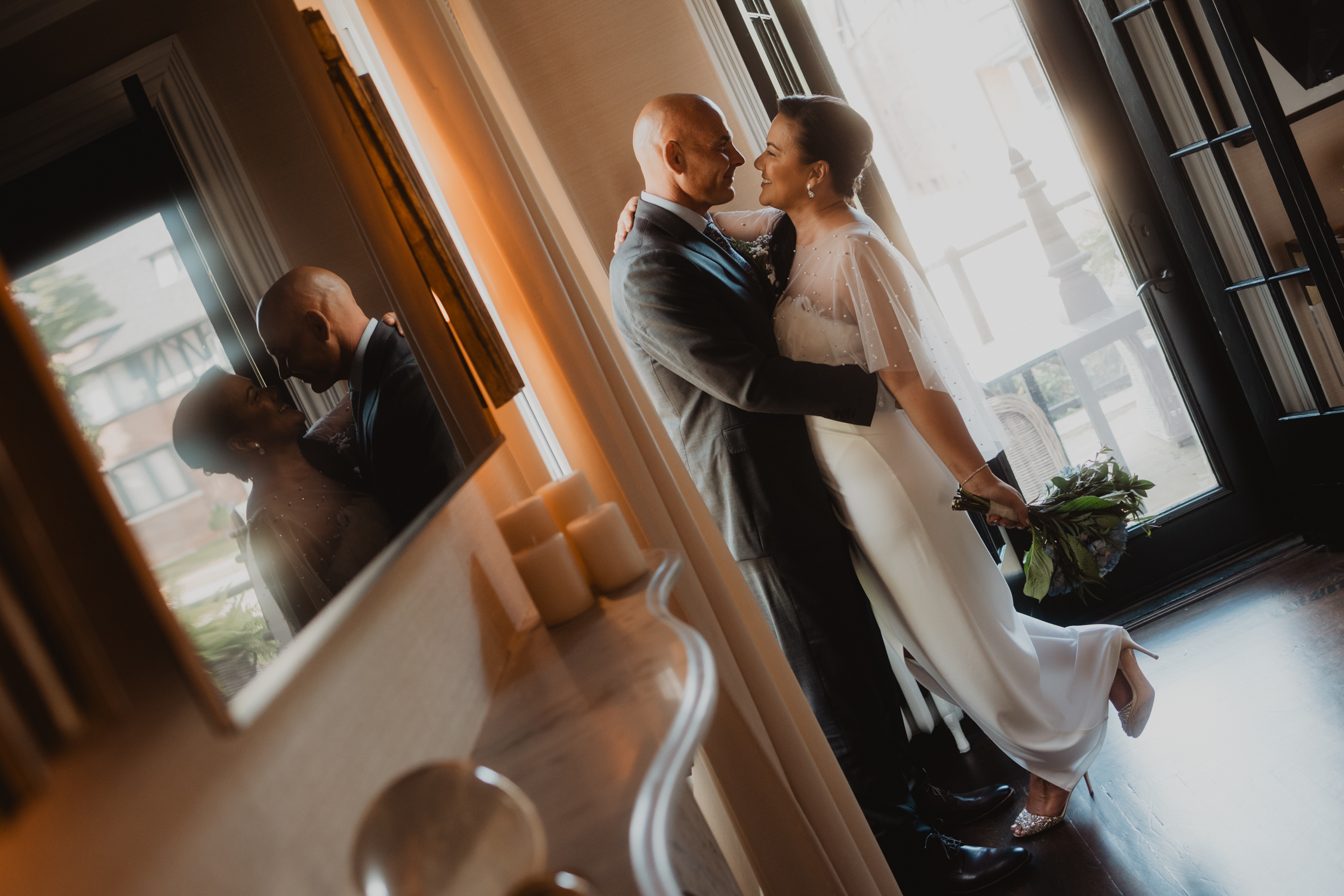 A tender moment between a wedding couple dancing inside Sarah St. Amand’s Brantford studio, just before sharing a kiss.