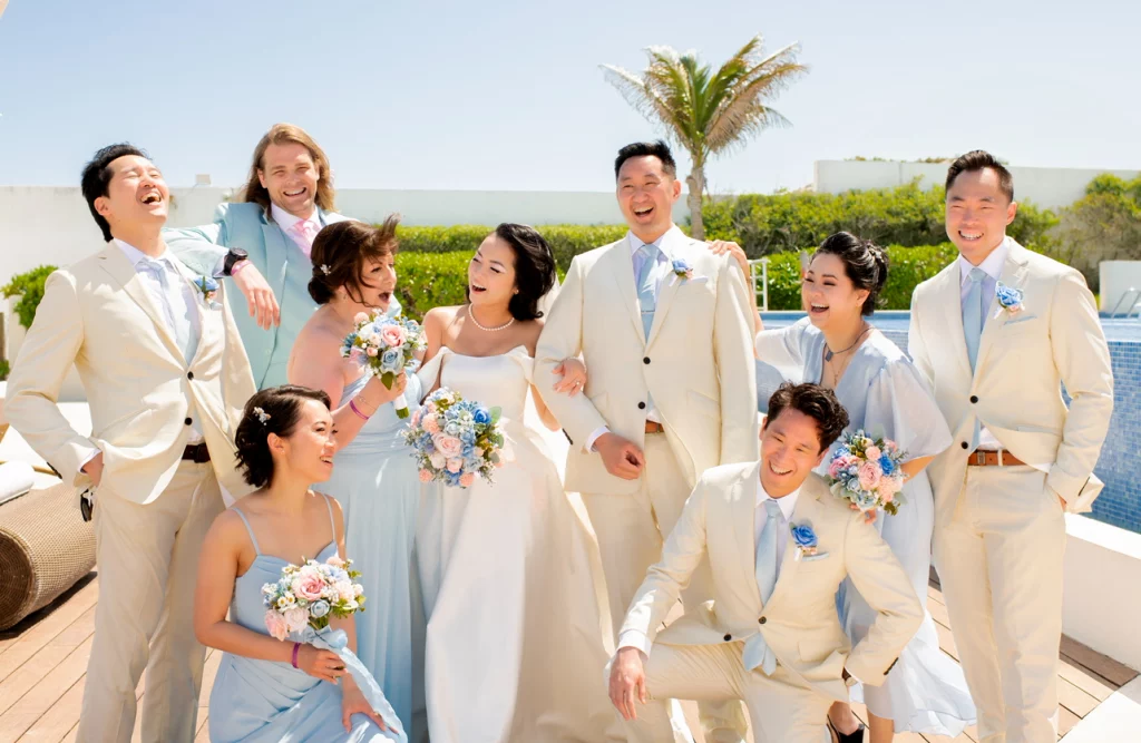 Guests celebrating under string lights at a beach wedding in Mexico