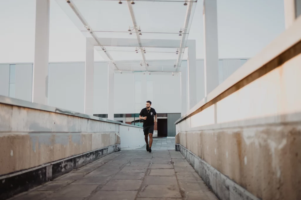 Male model running next to Brantford YMCA in downtown Brantford.