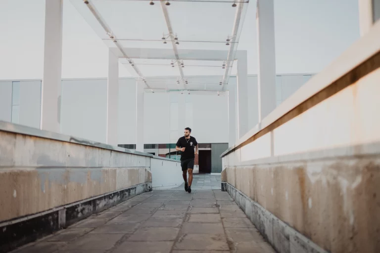 Male model running next to Brantford YMCA in downtown Brantford.