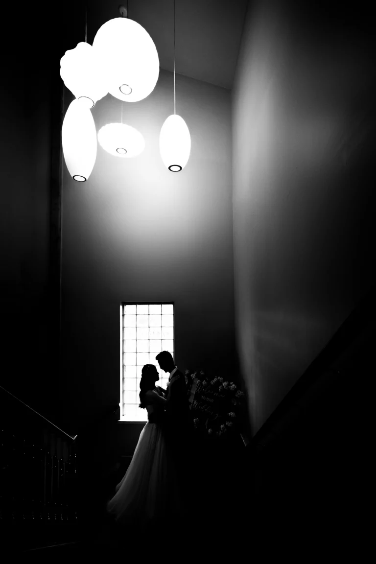 Black and white silhouette created through wedding photographer photography during a candid moment