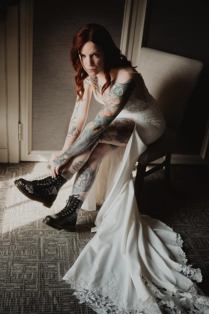 Alternative tatooed bride putting her Dr. Martines boots on.
