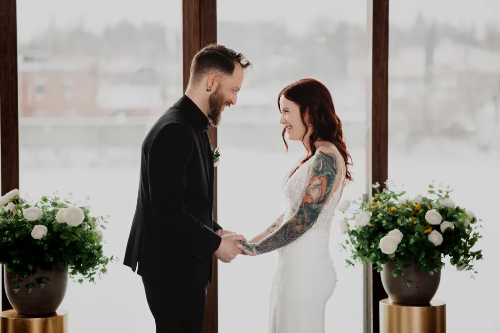 Beautiful candid moment during ceremony when bride and groom looking at each other and laughing.