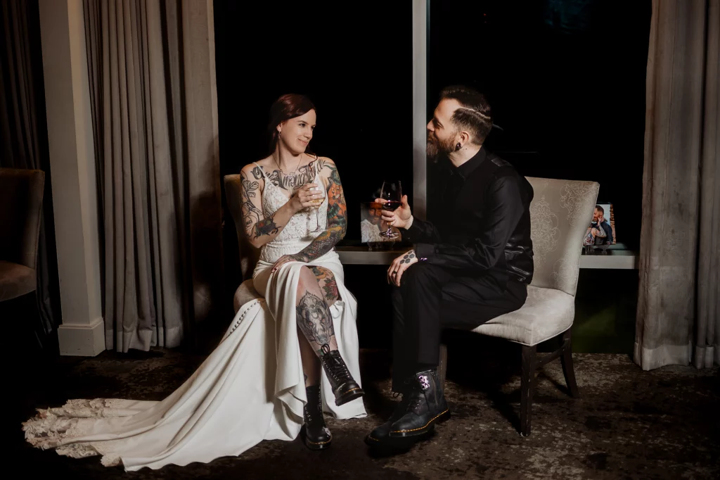 Couple are sitting talking and drinking at the end of the night.