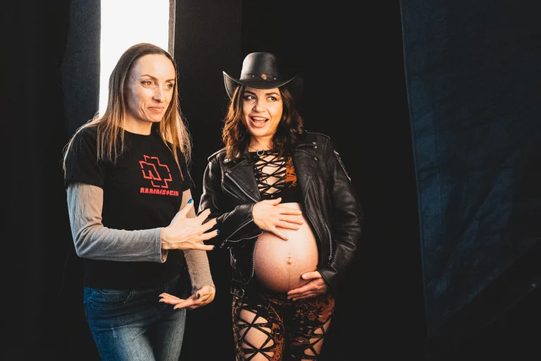 Behind the scenes of a studio portrait photography maternity photoshoot with photographer guiding the client posing